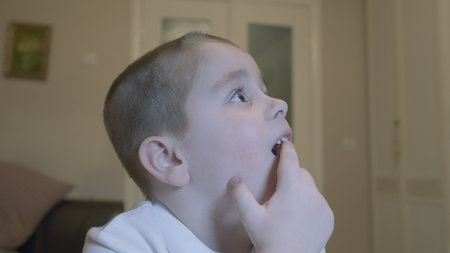 Child Wiggling His Front Milk Teeth. Child Showing His Milk Tooth Before Losing It. Replacement Of...