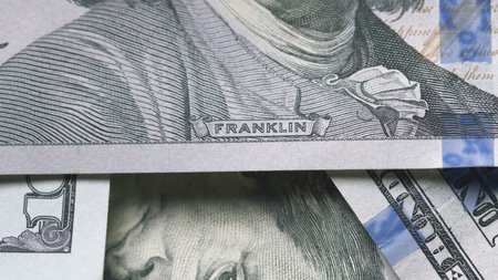 A closeup shot showcases US currency prominently featuring the notable figure Benjamin Franklin