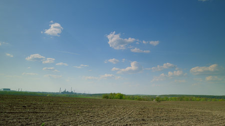 A Beautiful Scenic Landscape Featuring a Cloudy and Expansive Sky Over Vast Agricultural Landの写真素材