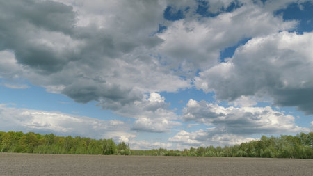 A Beautiful Skyscape Over a Tranquil Landscape Rich with Lush Foliage and Serenityの写真素材