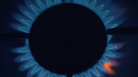 Illuminating Flames A CloseUp and Detailed View of a Gas Burner Functioning in Action