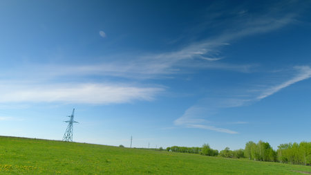 A Serene Green Landscape Under a Clear Blue Sky That Evokes a Sense of Peace and Calmの写真素材