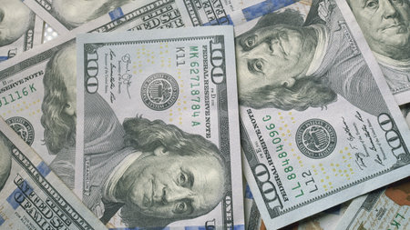 A pile of hundred dollar bills arranged to symbolize investment and wealth visuallyの写真素材