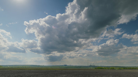 A picturesque and scenic cloudy sky gracefully spreads over the fields belowの写真素材