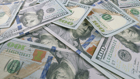 Several Stacked U.S. Dollar Bills Neatly Arranged on a Table in a Business Setting