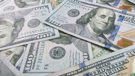 A closeup view showcasing Various U.S. Dollar Bills neatly arranged on a Table surface