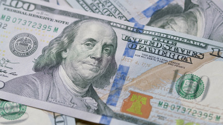 Detailed CloseUp Image of American Hundred Dollar Bills with Various Financial Contextsの写真素材