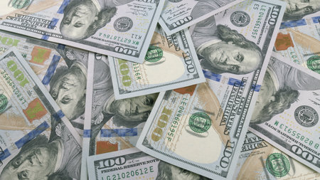 A CloseUp View of Scattered Dollar Bills on a Surface, Showcasing Different Denominations and Sidesの写真素材