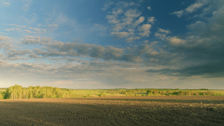 Experience a breathtaking and serene landscape featuring rolling fields and dramatic skies Time lapse.の写真素材