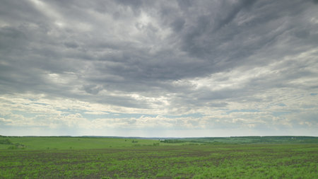 A Serene Landscape Featuring Stunning and Dramatic Cloudy Skies That Captivate the Eye Time lapse.の写真素材