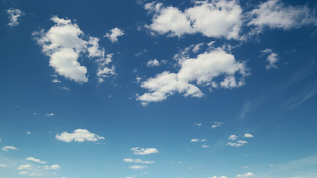 The Beautiful Blue Sky with Fluffy Clouds creates a Tranquil and Serene Nature Sceneの写真素材