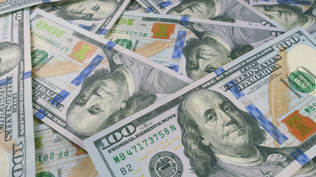 United States Dollar Bills Spread Out on a Flat Surface for Viewing or Analysis Purposeの写真素材