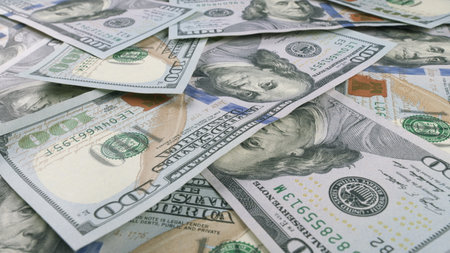 A CloseUp View of Various Different U.S. Dollar Bills Beautifully Laid Out on a Table Surfaceの写真素材
