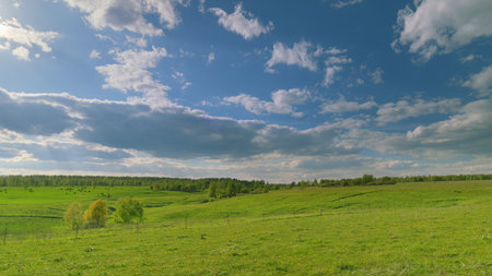 A Serene Countryside Landscape featuring Beautiful Lush Green Hills and Scenic Views Time lapse.の写真素材