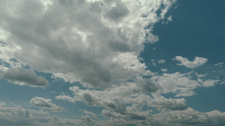 A Beautiful Cloudy Sky Filled with Dynamic Cloud Formation and Fluffy Clouds Above Time lapse.の写真素材