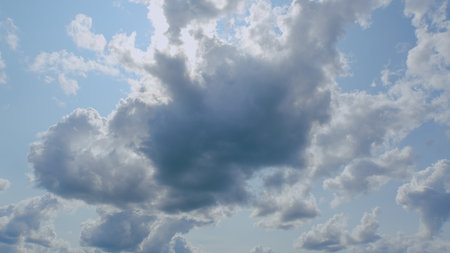 A Beautiful and Fluffy Cloudscape Set Against a Bright Clear Sky Filled with Peaceful Blissの写真素材