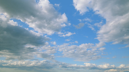 The Expansive Vast Blue Sky Enveloped with Fluffy, White Clouds that Evoke Serenityの写真素材