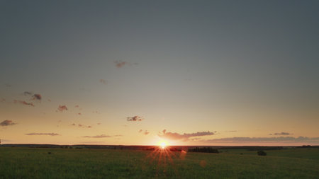 Experience the Stunning Sunrise Over a Serene and Beautiful Landscape this morningの写真素材