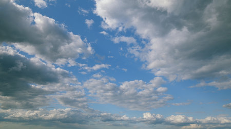 A dynamic overview of a cloudy sky filled with changing and evolving patterns of cloud formationsの写真素材
