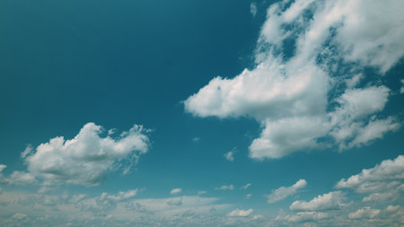 Time lapse. A Beautiful Serene Blue Sky Adorned with Fluffy White Clouds Floating Gracefully