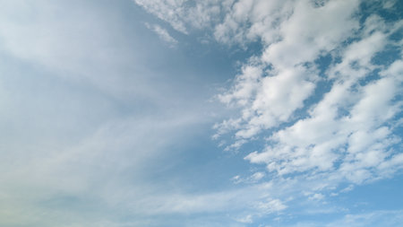 Time lapse. A beautiful and serene sky adorned with softly drifting and whispering clouds above usの写真素材