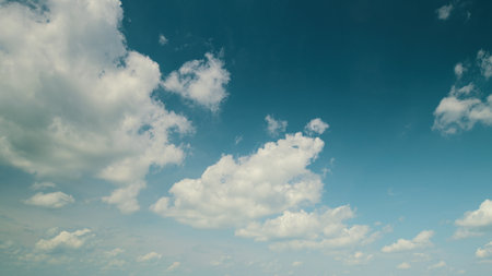 Time lapse. A Beautiful and Clear Blue Sky Adorned with Fluffy White Clouds That Inspire and Bring Joyの写真素材