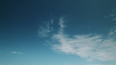 Time lapse. A Beautiful and Enchanting Cloudy Sky with a Tranquil Blue Background Enveloping the Atmosphereの写真素材