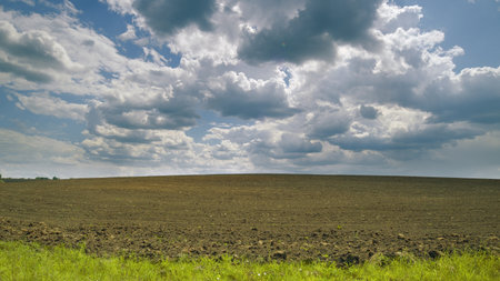 An Expansive Farm Landscape With Dramatic Clouds Capturing the Essence of Natures Beauty Around Us Time lapse.の写真素材