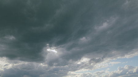 An Incredible and Dramatic Cloud Formation with Intermittent Rays of Sunlight Peeking Throughの写真素材