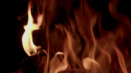 Captivating and Enigmatic Flames Dancing Gracefully in the Embrace of the Dark Nightの写真素材