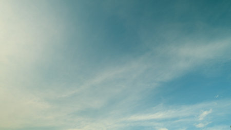 Time lapse. A Serene Blue Sky with Soft Clouds that Creates a Tranquil and Peaceful Atmosphereの写真素材