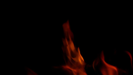 Dynamic Flames Dancing Vividly Against a Rich, Deep Black Background Creating a Striking Contrastの写真素材