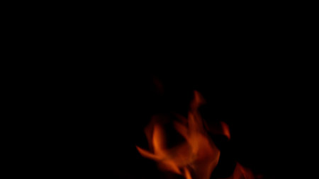 Captivating and mesmerizing flames elegantly dance gracefully in the surrounding darknessの写真素材