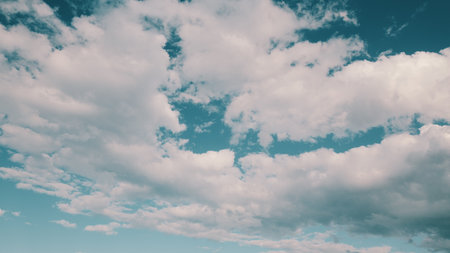 A Beautiful Cloudy Sky with a Bright Blue Background creates a charming atmosphere