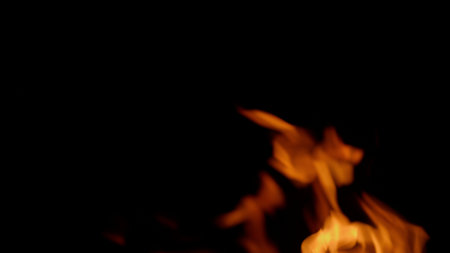 Dynamic flames dance beautifully in darkness, creating a captivating display of light and heat