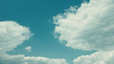 Experience the breathtaking beauty of a cloudy sky with a vibrant blue background