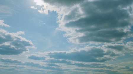 A Serene and Beautiful Sky Filled with Wispy Clouds and Bright Sunlight Shining Through