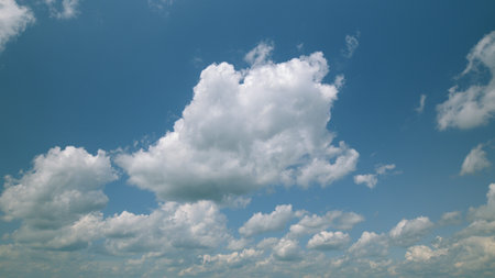 Time lapse. A Beautiful Blue Sky adorned with Fluffy White Clouds that inspire feelings of peace and...