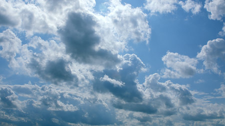 A Beautiful and Cloudy Sky Showcasing Intermittent Sunlight Peeking Through the Clouds