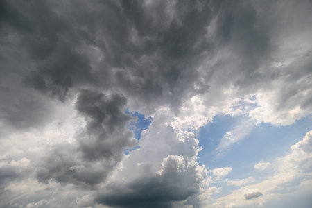 A Stunningly Dramatic Sky Displaying Darker Clouds with Beautiful Blue Gaps Appearing Between Them