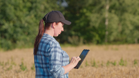 An Agricultural Researcher Utilizing a Tablet Device While Conducting Field Research