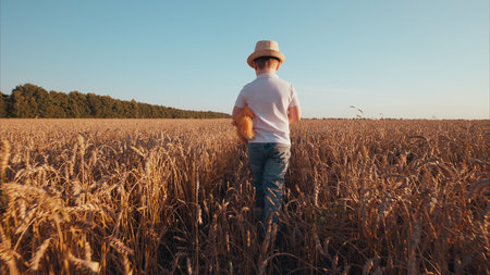 A Child Enthusiastically Exploring a Serene Wheat Field During the Golden Hour of Evening