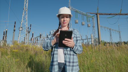 An Engineer Conducting a Thorough Inspection of Electrical Equipment Located in a Field