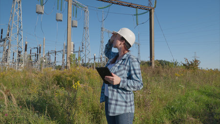 A dedicated energy sector worker meticulously inspecting a power facility for safety and efficiency