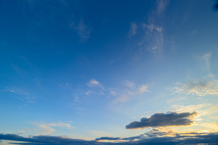 Tranquil Evening Sky with Soft, Fluffy Clouds and Beautiful Blue Hues Gracing the Horizonの写真素材