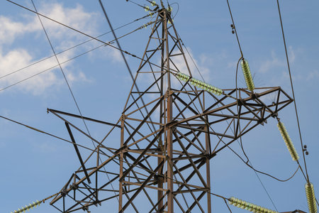 A Metal Power Tower Stands Tall Against the Clear Blue Sky, Showcasing Modern Design Elements