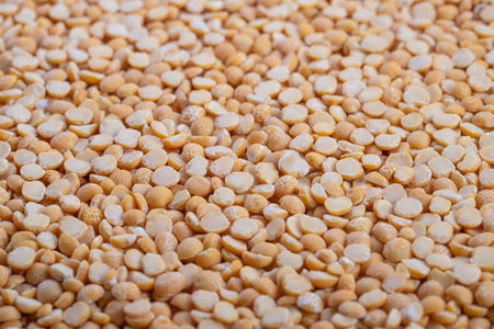 Closeup organic yellow split peas grain, evokes farmtotable sustainability and harvest inspiration,...
