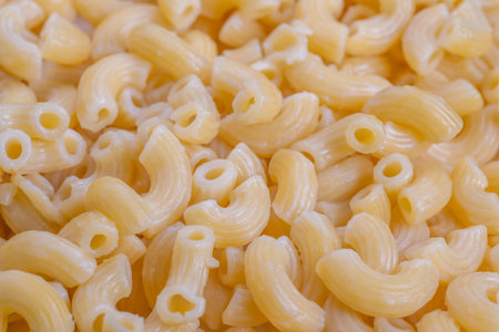 Rustic pasta imagery, Closeup of handcrafted uncooked pasta revealing detailed ridges, Artisan uncooked pasta with textured ridges evokes nostalgic culinary imagery for featuresの写真素材