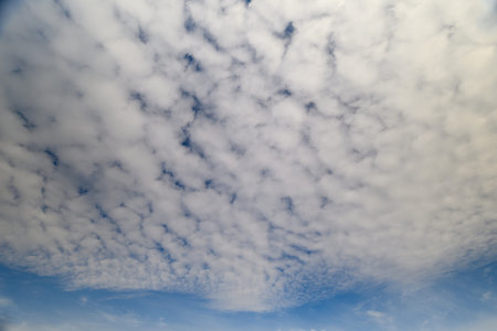 A Vast and Endless Sky Adorned with Soft, Fluffy Clouds in Various Beautiful Shades of Blue
