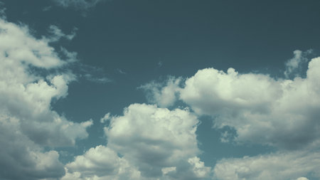 A Serene Cloudy Sky adorned with Soft, Fluffy White Clouds gently floating aboveの写真素材